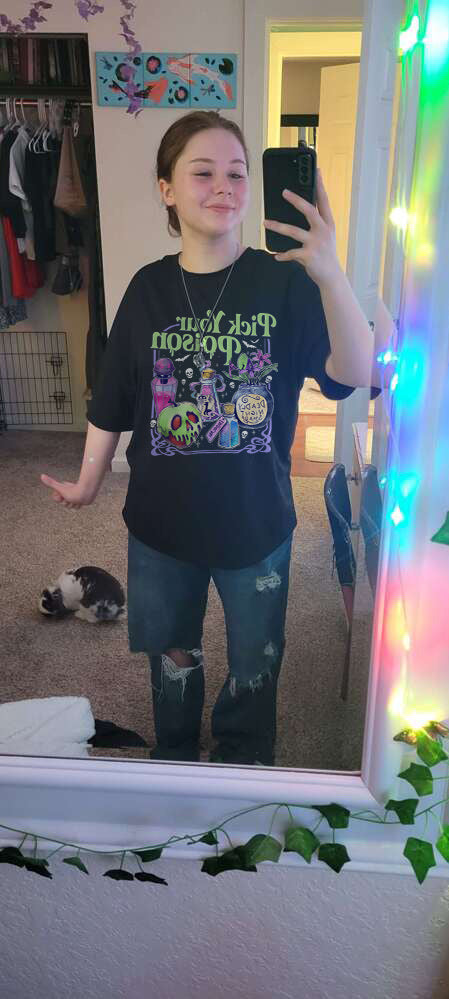 Customer wearing a black Pick Your Poison shirt