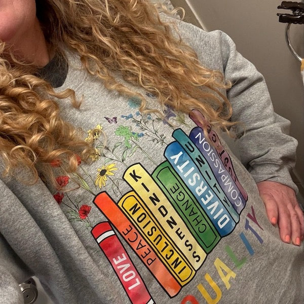 Customer wearing a sweatshirt celebrating love, inclusion, diversity and equality